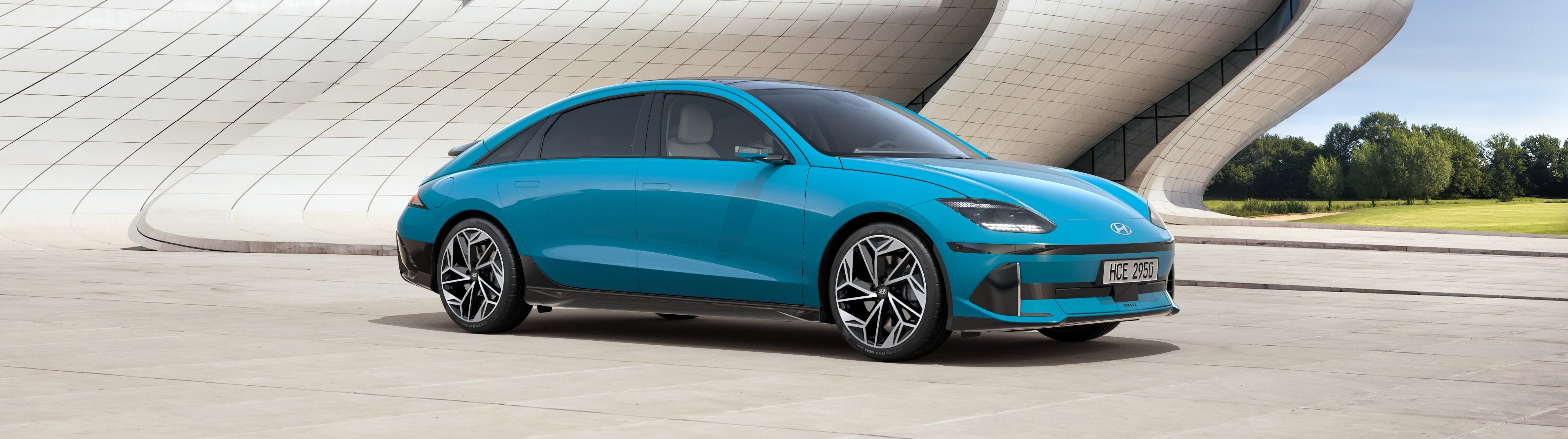 Blue electric car parked outdoors.