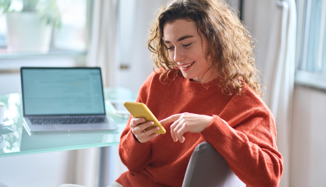 Lady smiling at mobile phone