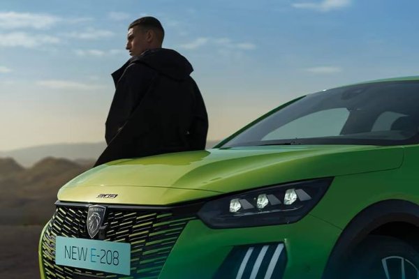 Man leaning against Peugeot car