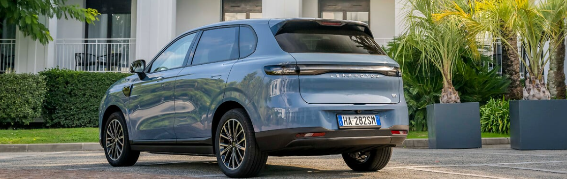 Blue SUV parked outdoors, view of rear and side.