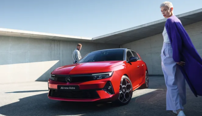 Red astra with 2 people
