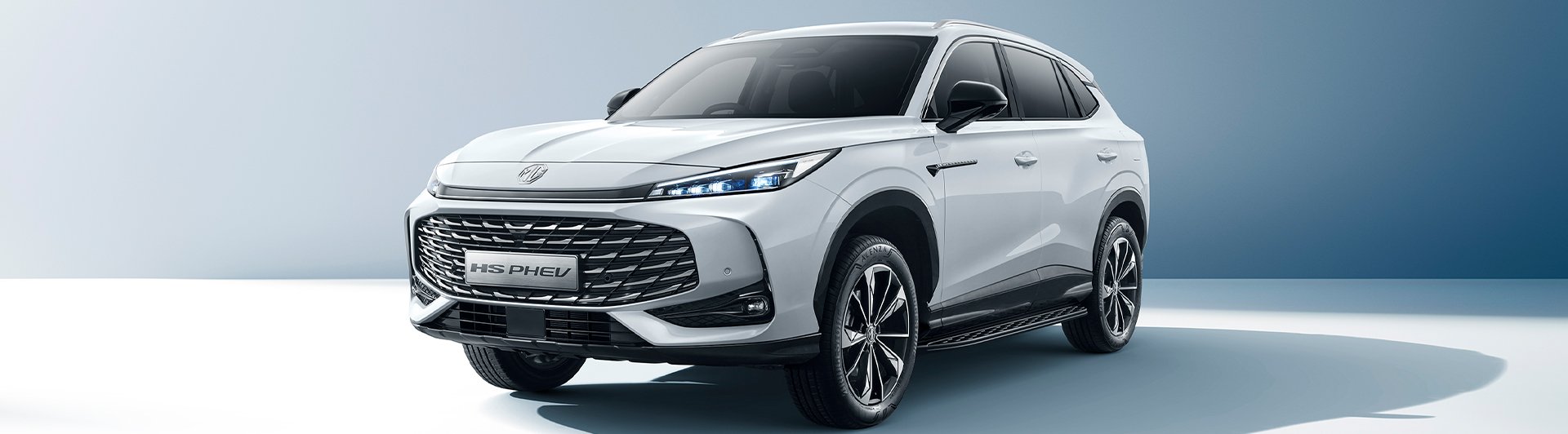 White SUV front view with angular headlights and prominent grille.